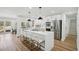 Kitchen with island and barstool seating, stainless steel appliances, and direct access to the back deck at 7410 Fields Dr, Cumming, GA 30041