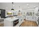 Modern kitchen featuring a kitchen island, stainless steel appliances, and an open-concept design at 7410 Fields Dr, Cumming, GA 30041