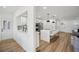 Modern kitchen with open floor plan, kitchen island with barstool seating, and stainless steel appliances at 7410 Fields Dr, Cumming, GA 30041
