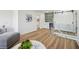 Open living area featuring a bar with modern sliding doors and wood floors at 7410 Fields Dr, Cumming, GA 30041