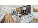Inviting living room with a modern fireplace, gray sofas, and wood flooring at 7410 Fields Dr, Cumming, GA 30041