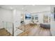 Upstairs bonus area featuring hardwood floors, cozy seating, tv, and great natural light at 7410 Fields Dr, Cumming, GA 30041