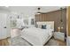 Spacious main bedroom with modern wood accent wall and seating area at 7410 Fields Dr, Cumming, GA 30041