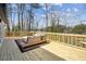Expansive wooden deck offers outdoor living space with comfortable seating and scenic water views at 7410 Fields Dr, Cumming, GA 30041