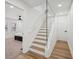 Stylish staircase with glass railings and a combination of carpet and wood flooring, adding a modern touch at 7410 Fields Dr, Cumming, GA 30041