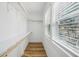 Walk-in closet with shelving and storage space next to window with blinds at 7410 Fields Dr, Cumming, GA 30041