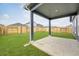 Covered back patio offering a view of the spacious, fenced backyard with well-maintained lawn at 112 Asher Dr, Carrollton, GA 30116