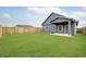 Well-maintained backyard with green lawn, privacy fence, and covered patio at 112 Asher Dr, Carrollton, GA 30116