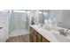 Bright bathroom features a double sink vanity and spacious shower with glass doors at 112 Asher Dr, Carrollton, GA 30116