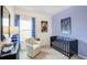 A stylish Bedroom with blue accents, decorative paintings, and a comfortable armchair at 112 Asher Dr, Carrollton, GA 30116