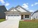 Charming home featuring a two-car garage, craftsman-style accents, and a well-manicured lawn at 112 Asher Dr, Carrollton, GA 30116