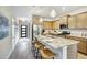Open kitchen featuring a large island with seating, stainless steel appliances, and wood cabinetry at 112 Asher Dr, Carrollton, GA 30116