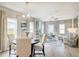 Open-concept dining and living room featuring elegant decor, fireplace and bright windows at 112 Asher Dr, Carrollton, GA 30116