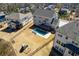 Wide aerial view of a backyard featuring a pool, playset, and deck, set amongst neighboring homes at 1775 Rockwater Rd, Marietta, GA 30066