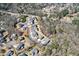 Aerial view of a quiet residential area with well-spaced houses surrounded by lush trees and a winding road at 1775 Rockwater Rd, Marietta, GA 30066