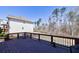 Wooden deck overlooking a wooded backyard with a play set, ideal for outdoor relaxation at 1775 Rockwater Rd, Marietta, GA 30066