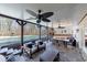 Covered outdoor patio with ceiling fans, comfortable seating, and a view of the sparkling pool and playground at 1775 Rockwater Rd, Marietta, GA 30066