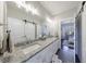 Elegant bathroom features granite countertops, double sinks, and a sliding barn door for added privacy at 1775 Rockwater Rd, Marietta, GA 30066