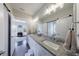 Bathroom featuring granite countertops, double sinks, and a view into another room at 1775 Rockwater Rd, Marietta, GA 30066