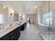 Spa-like bathroom with marble floors, soaking tub, frameless glass shower and dual vanities, perfect for relaxation at 1775 Rockwater Rd, Marietta, GA 30066