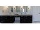 Bathroom featuring dual vanities, lots of storage, and contemporary finishes at 1775 Rockwater Rd, Marietta, GA 30066