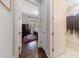 Bedroom entryway featuring hardwood floors, a dresser, and a glimpse into the bathroom at 1775 Rockwater Rd, Marietta, GA 30066