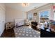 Brightly lit bedroom featuring hardwood floors, a large area rug, and two windows for plenty of natural light at 1775 Rockwater Rd, Marietta, GA 30066