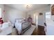 Sun-filled bedroom features wood floors, a patterned rug, and charming decor create a welcoming space at 1775 Rockwater Rd, Marietta, GA 30066