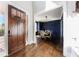 Elegant entryway with dark wood door and hardwood floors, leading to dining room at 1775 Rockwater Rd, Marietta, GA 30066