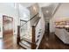 Grand foyer showcasing hardwood floors, staircase with dark treads, and a view of the kitchen at 1775 Rockwater Rd, Marietta, GA 30066