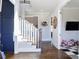 Elegant foyer with dark hardwood floors, staircase, and view of the playroom through doorway at 1775 Rockwater Rd, Marietta, GA 30066
