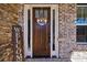 Inviting front door adorned with a wreath and welcome sign, set against a brick facade at 1775 Rockwater Rd, Marietta, GA 30066