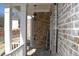Inviting front porch featuring brick accents, classic white columns, and a 'Welcome' sign for a warm greeting at 1775 Rockwater Rd, Marietta, GA 30066