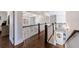 Beautiful upstairs hallway with hardwood floors, white railings, and coffered ceilings leading to multiple rooms at 1775 Rockwater Rd, Marietta, GA 30066