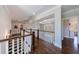 Upstairs hallway with beautiful hardwoods, coffered ceilings and neutral color palette exudes elegance and charm at 1775 Rockwater Rd, Marietta, GA 30066