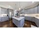Modern kitchen with gray cabinets, stainless steel appliances, and a center island with white countertop at 1775 Rockwater Rd, Marietta, GA 30066