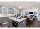 Bright kitchen features an island, stainless appliances, and an open layout with views into the living area at 1775 Rockwater Rd, Marietta, GA 30066
