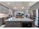 Modern kitchen with gray cabinets, a large island, stainless appliances, and pendant lighting at 1775 Rockwater Rd, Marietta, GA 30066