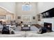 Open living room with fireplace, soaring ceilings, large windows, and views into the adjacent kitchen at 1775 Rockwater Rd, Marietta, GA 30066