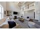 Open living room with fireplace, soaring ceilings, large windows, and a cozy seating arrangement at 1775 Rockwater Rd, Marietta, GA 30066