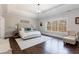 Spacious main bedroom with tray ceilings, hardwood flooring, lots of natural light and elegant decor at 1775 Rockwater Rd, Marietta, GA 30066
