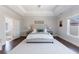 Bright main bedroom features a tray ceiling, lots of light, hardwood flooring, and ensuite bathroom at 1775 Rockwater Rd, Marietta, GA 30066