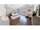 Bright main bedroom with a bench, hardwood floors, lots of natural light, and a decorative tray ceiling at 1775 Rockwater Rd, Marietta, GA 30066