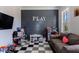Bright playroom with checkered floor tiles, shiplap accent wall, and a variety of toys at 1775 Rockwater Rd, Marietta, GA 30066