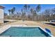 View of a swimming pool, backyard with playground, and bordering tall trees beyond the metal fence at 1775 Rockwater Rd, Marietta, GA 30066