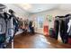Spacious walk-in closet features custom shelving, hardwood floors, and ample natural light from the window at 1775 Rockwater Rd, Marietta, GA 30066