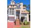 Charming multi-level home featuring a quaint front balcony, a garage, and a neatly landscaped front yard at 2270 Goodwood Se Blvd, Smyrna, GA 30080