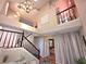 Grand foyer featuring staircase with black railing, tile floors, and high ceilings with modern chandeliers at 2270 Goodwood Se Blvd, Smyrna, GA 30080