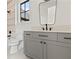 Modern bathroom featuring gray vanity, black hardware, and gray tile in shower at 56 Pine St, Roswell, GA 30075