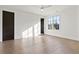 Bright bedroom with hardwood floors, a modern ceiling fan, and natural light through large windows at 56 Pine St, Roswell, GA 30075